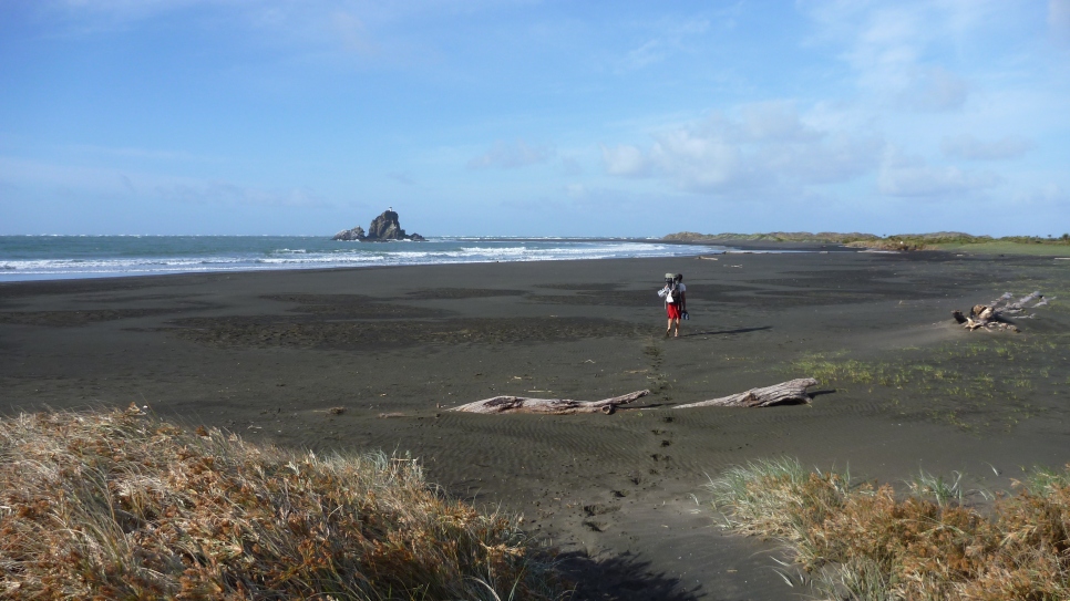 Hiking out along the black sand beach